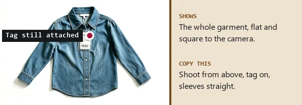 Denim shirt with a hang tag laid flat on a white surface, photographed from above